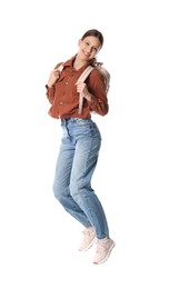 Photo of Smiling teenage girl with backpack jumping on white background