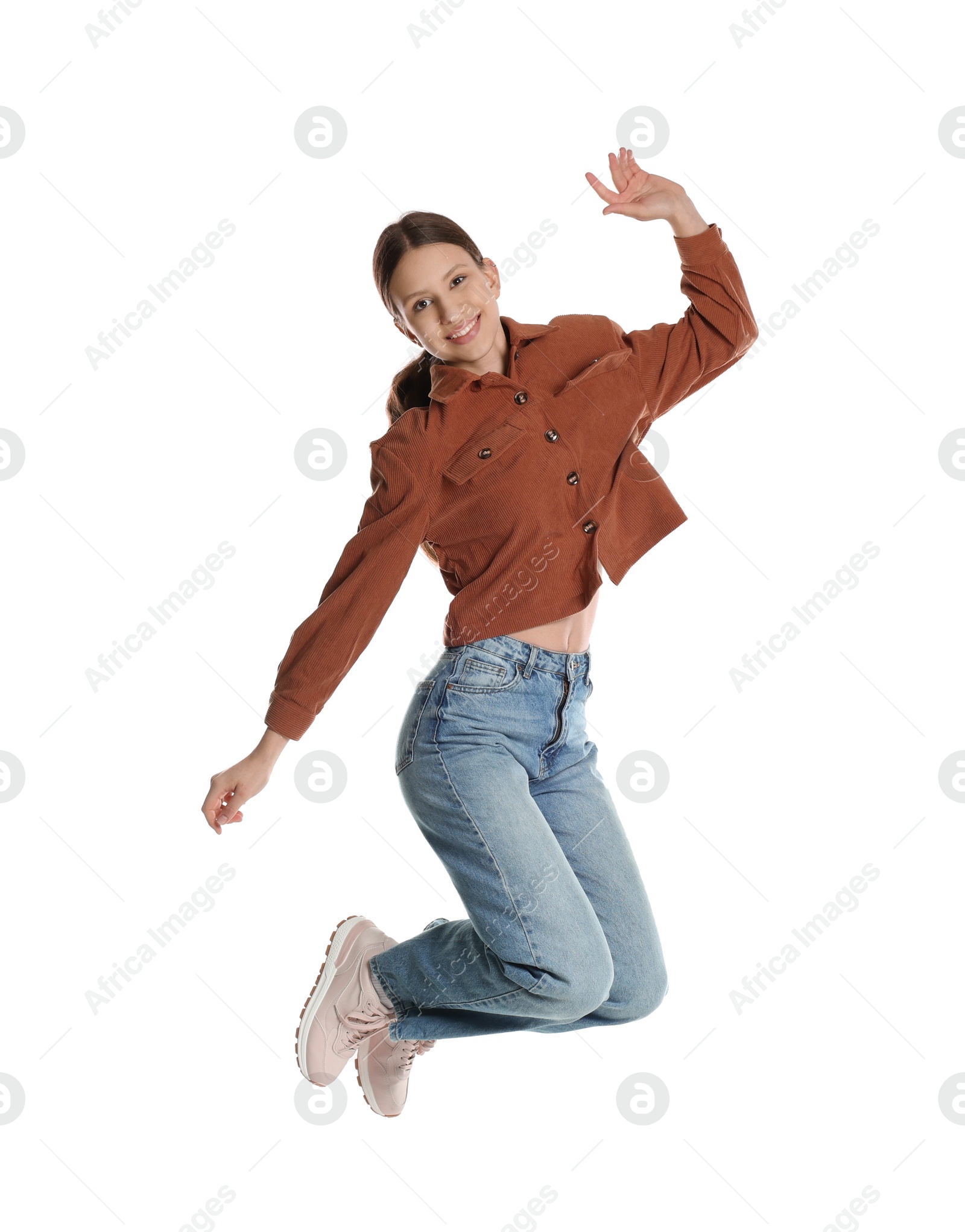 Photo of Smiling teenage girl jumping on white background