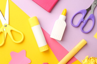 Photo of Flat lay composition with glue, scissors and other stationery on color background