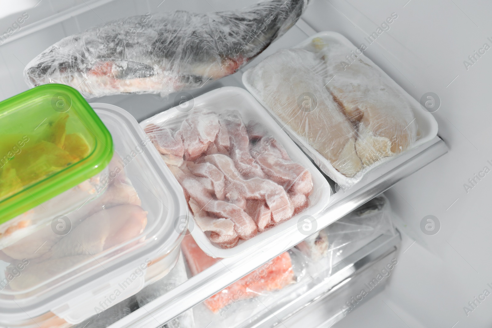 Photo of Different frozen meat and fish products in fridge