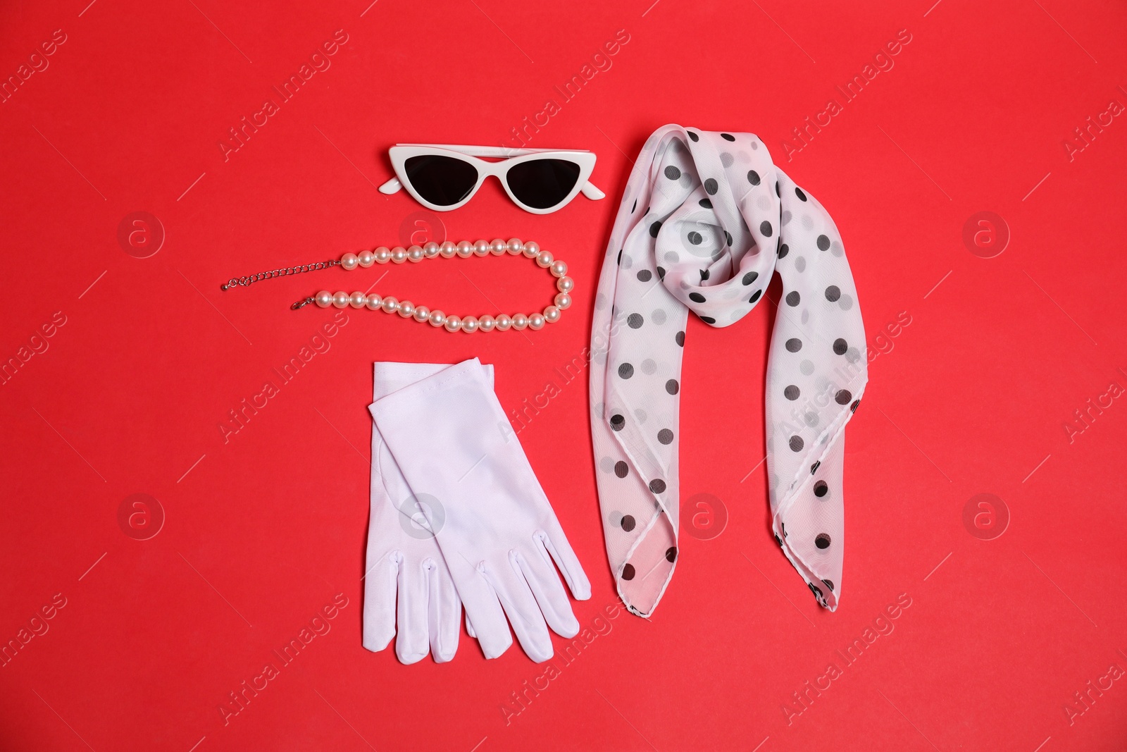 Photo of Stylish accessories on red background, flat lay