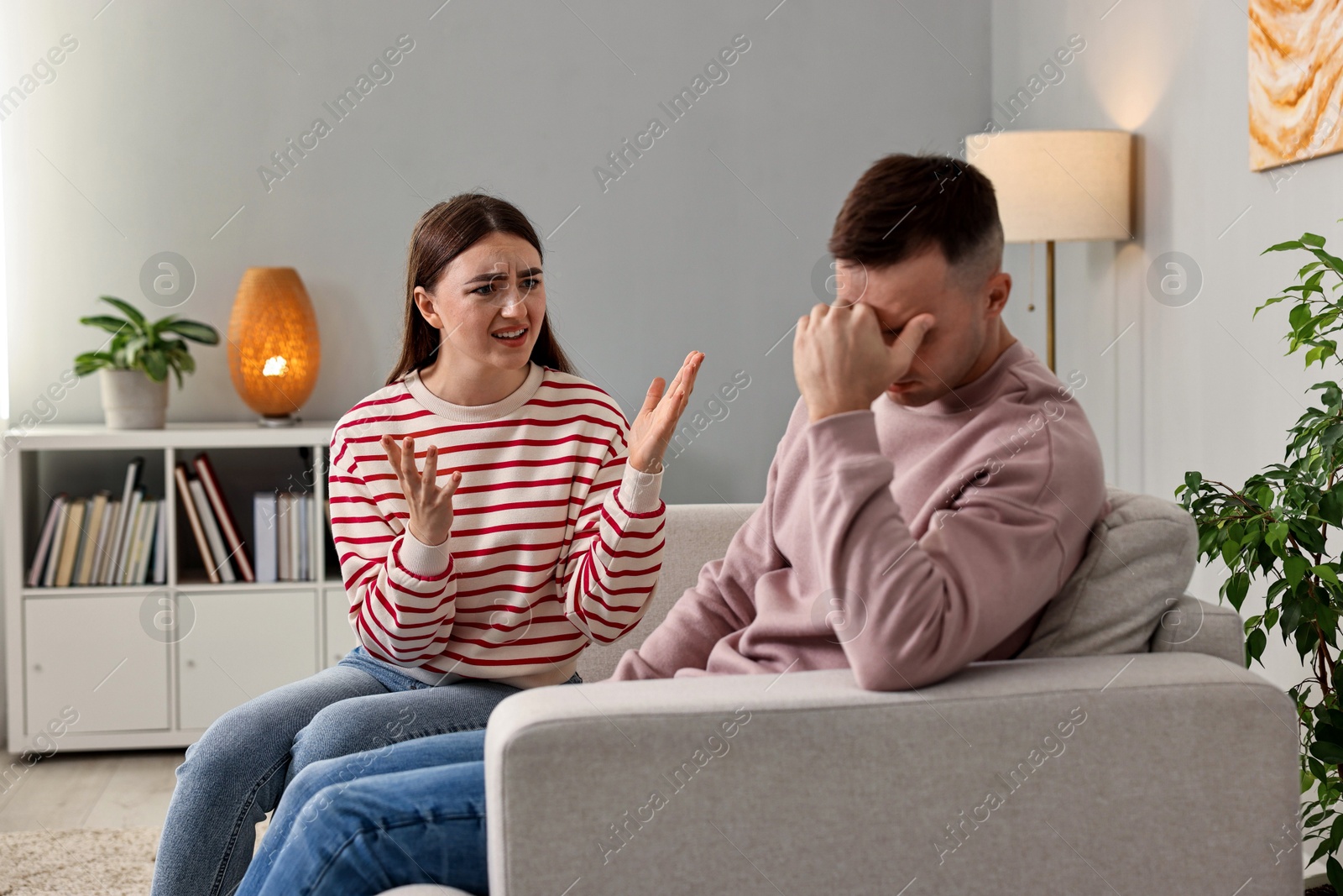 Photo of Husband ignoring his emotional wife at home