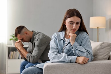 Photo of Offended couple ignoring each other at home