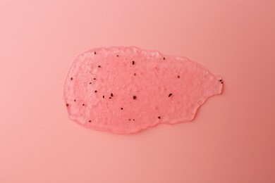 Photo of Smear of body scrub on light pink background, top view