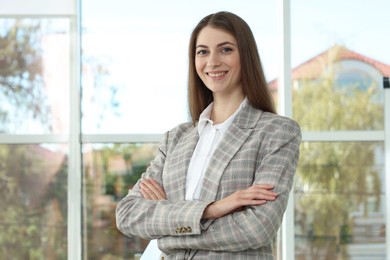 Photo of Portrait of young woman wearing stylish suit indoors