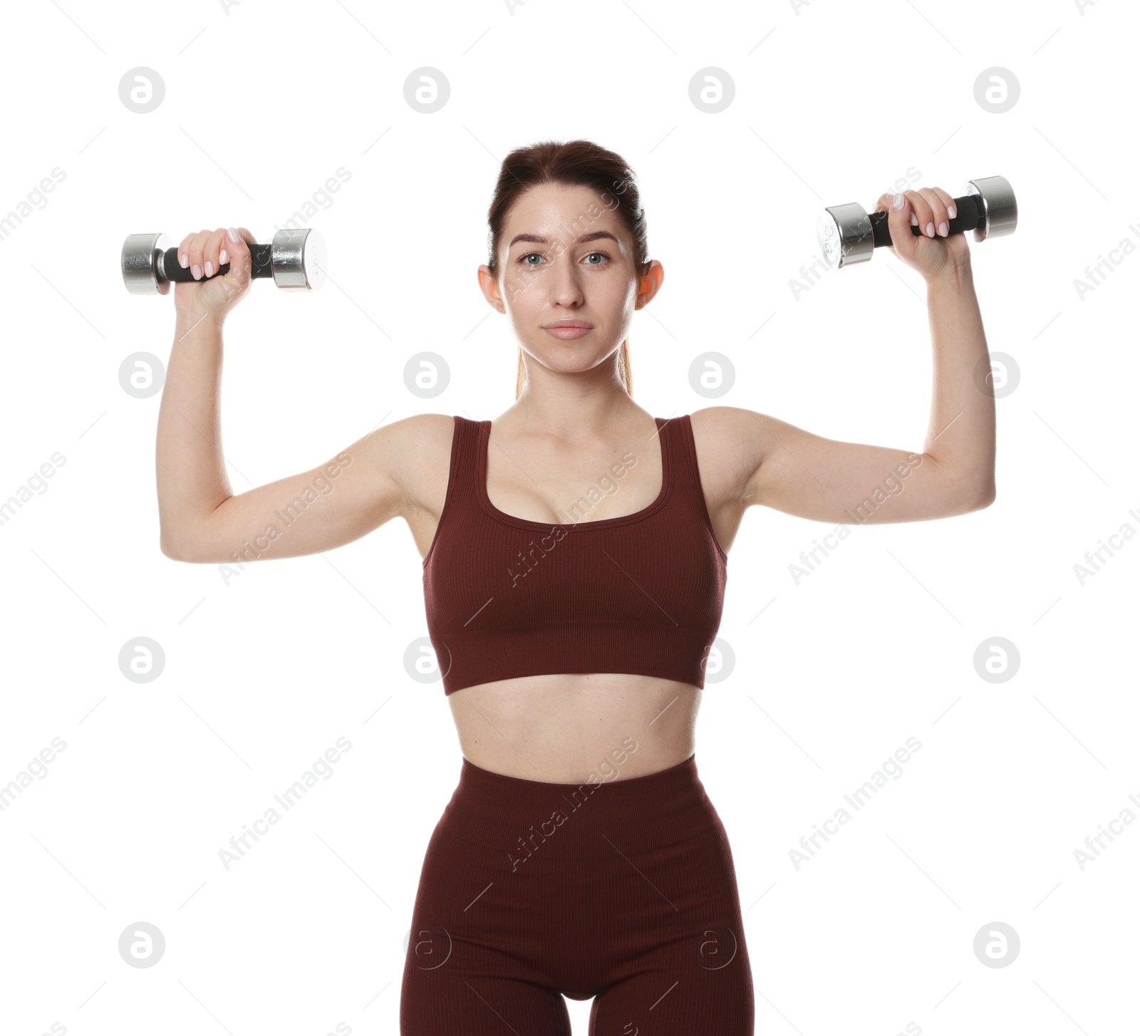 Photo of Woman in sportswear exercising with dumbbells on white background