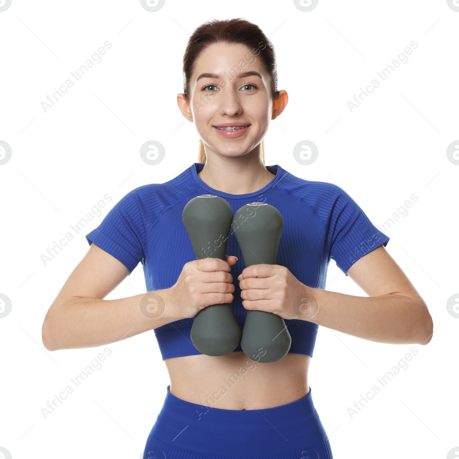 Photo of Woman in sportswear exercising with dumbbells on white background