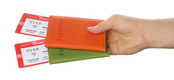 Photo of Travel agency. Man holding passports with flight tickets on white background, closeup