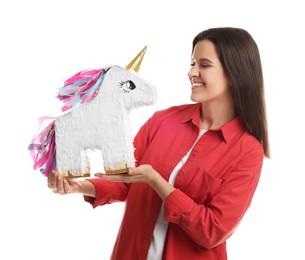 Happy woman with unicorn shaped pinata on white background