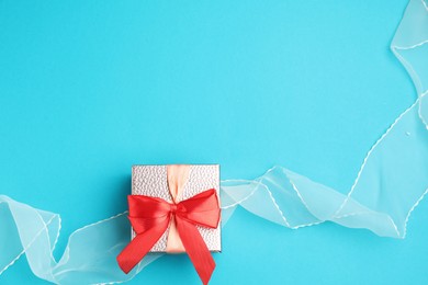 Photo of Romantic gift on light blue background, top view. Space for text