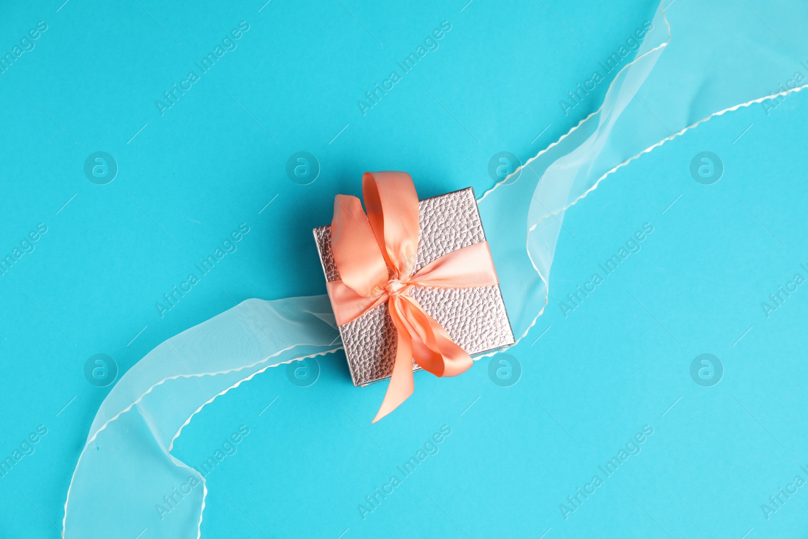 Photo of Romantic gift on light blue background, top view