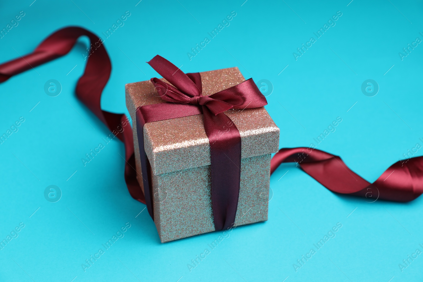 Photo of Romantic gift on light blue background, closeup