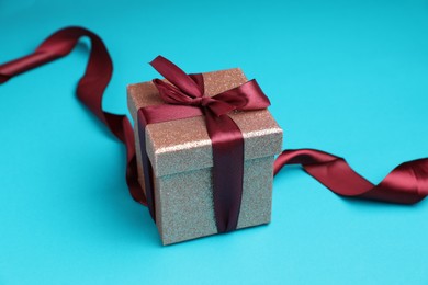 Photo of Romantic gift on light blue background, closeup