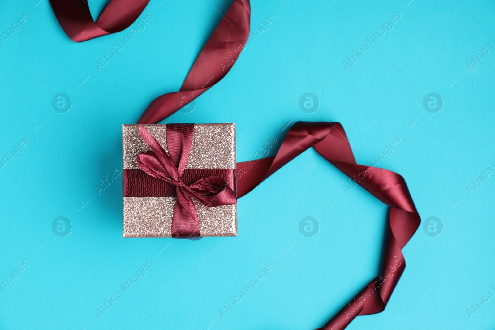 Photo of Romantic gift on light blue background, top view