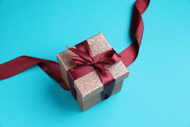 Romantic gift on light blue background, closeup