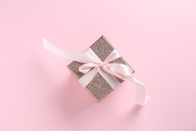 Romantic gift on light pink background, top view