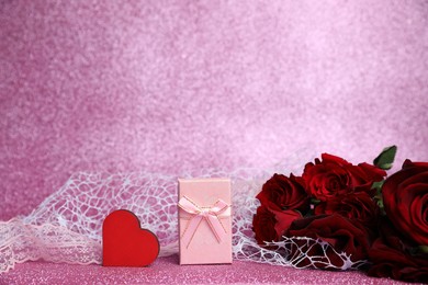 Photo of Romantic gift, heart and roses on pink background. Space for text