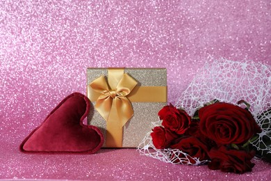 Photo of Romantic gift, heart and roses on pink background