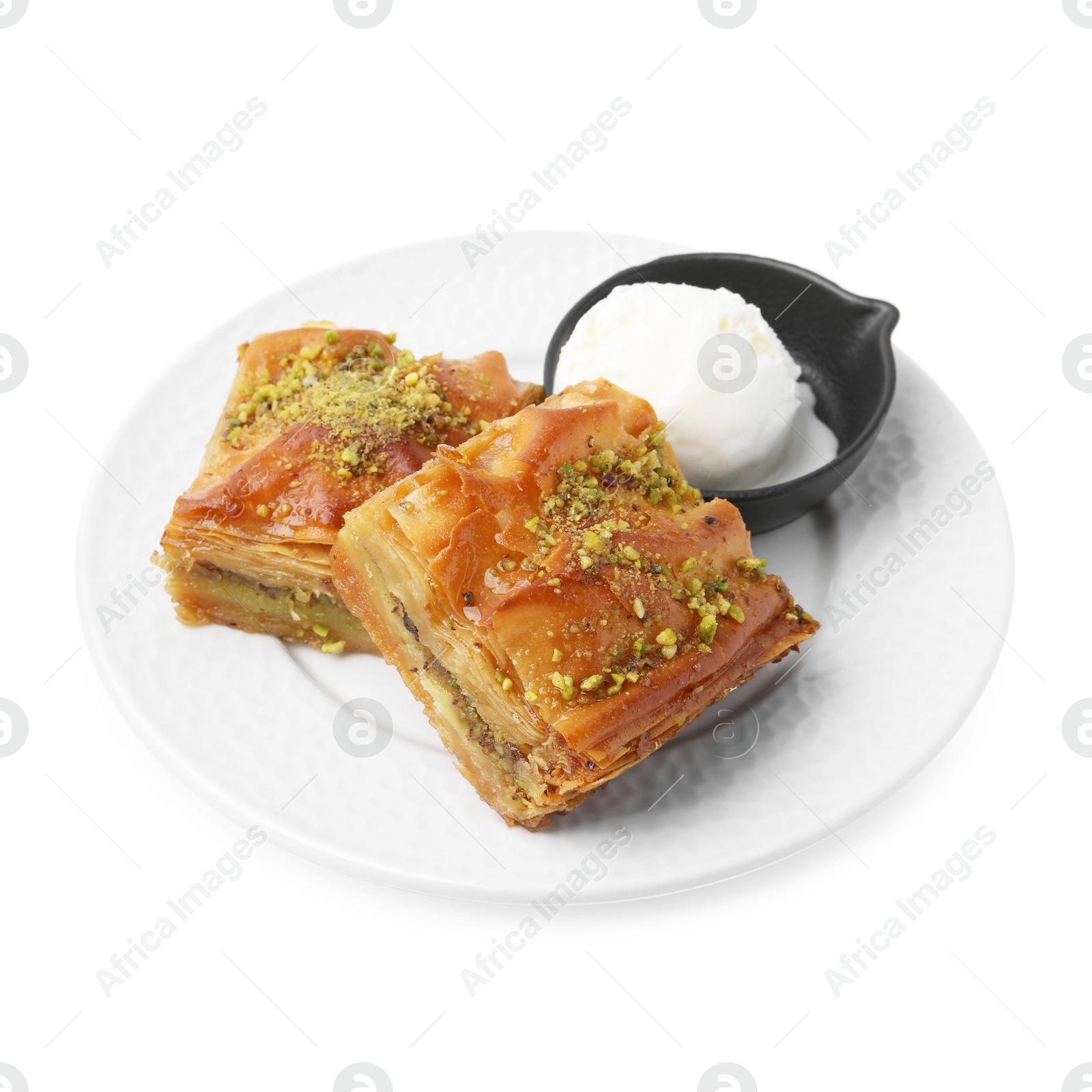 Photo of Delicious baklava with crushed nuts and ice cream isolated on white