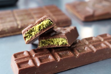 Tasty Dubai chocolate with pistachios and knafeh on grey table, closeup