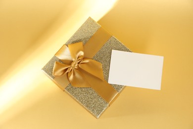 Romantic gift and blank card on beige background, top view. Space for text