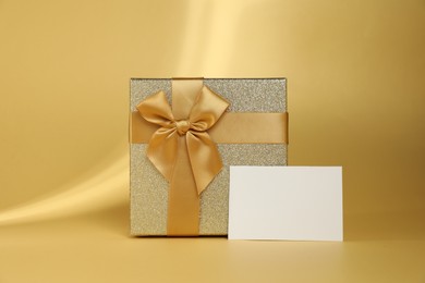 Photo of Romantic gift and blank card on beige background. Space for text