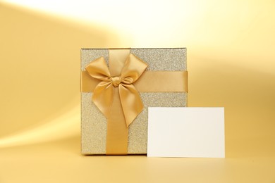 Photo of Romantic gift and blank card on beige background. Space for text