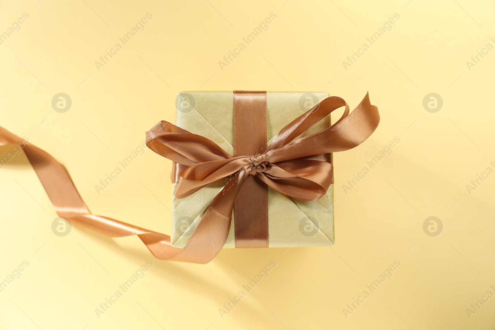 Photo of Romantic gift on beige background, top view