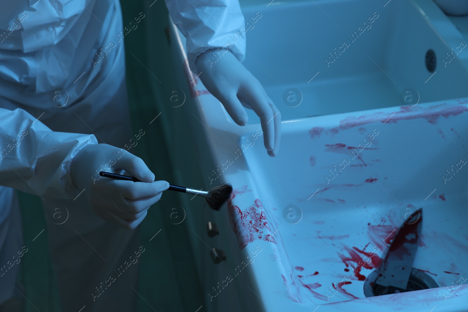 Photo of Forensic expert taking fingerprints from sink with brush at crime scene indoors, closeup