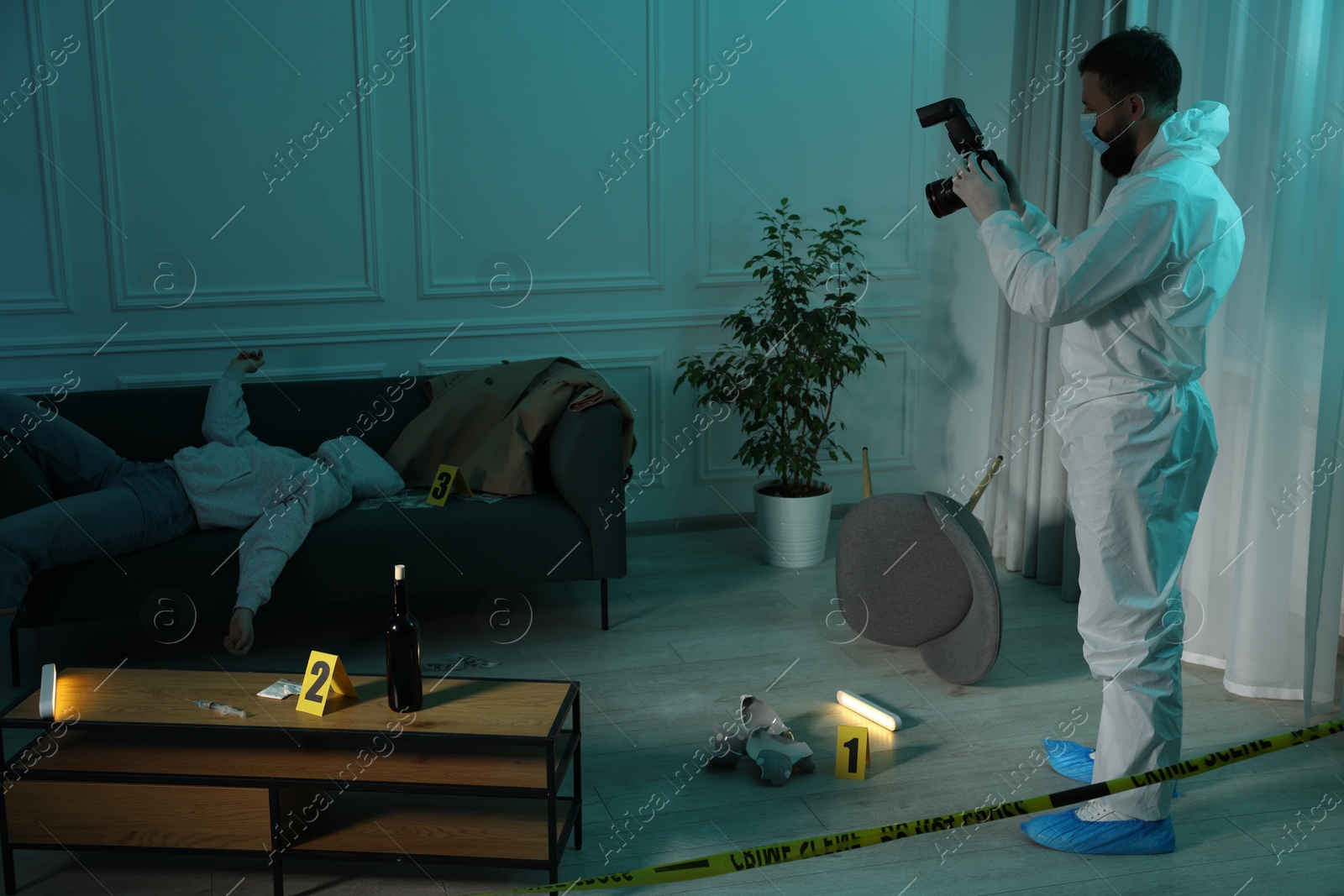 Photo of Forensic expert with camera working at crime scene and dead woman's body indoors