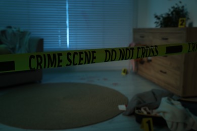 Photo of Yellow crime scene tape blocking way to messy room