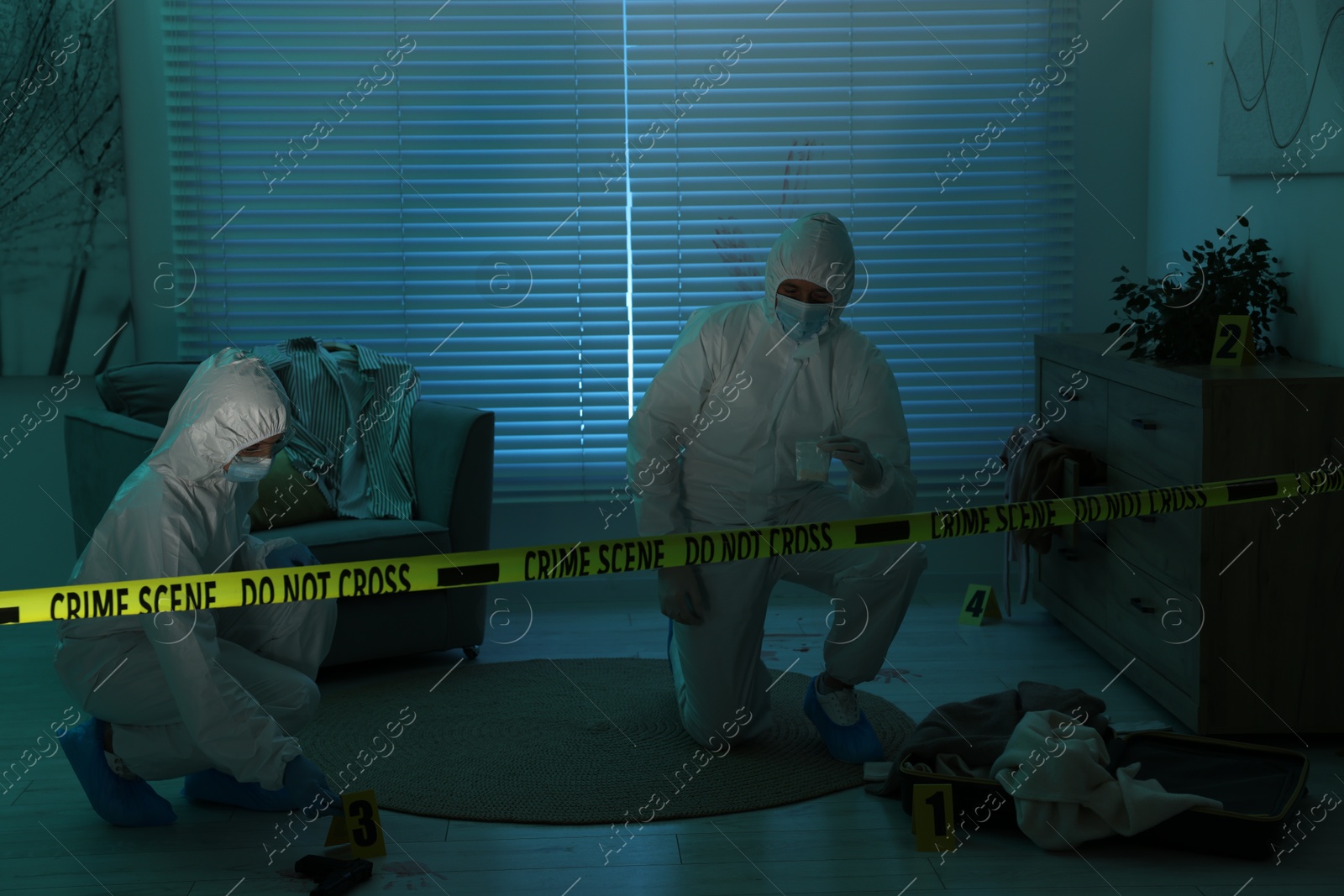 Photo of Forensic experts working at crime scene indoors