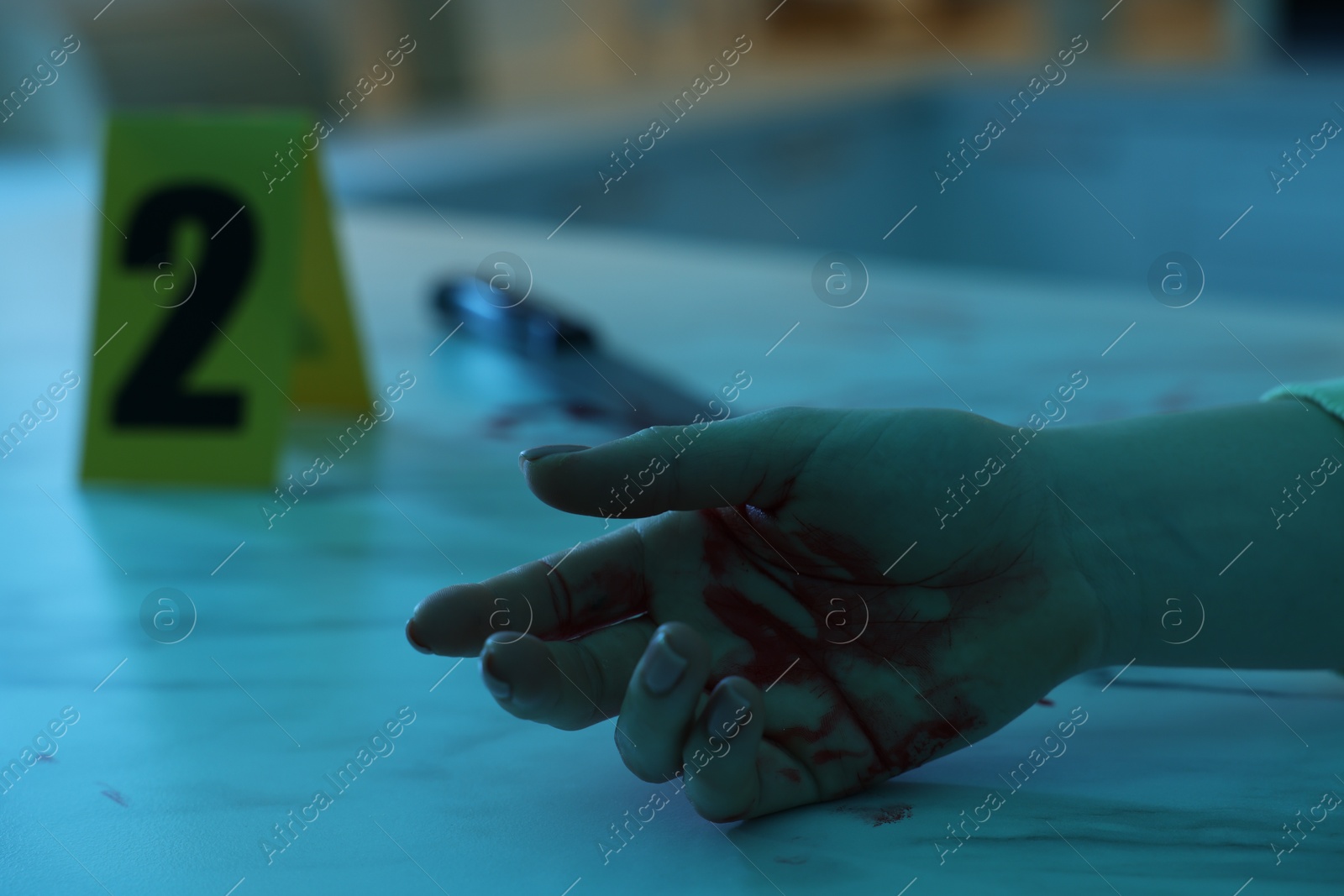 Photo of Dead woman's body with blood on marble countertop indoors, closeup