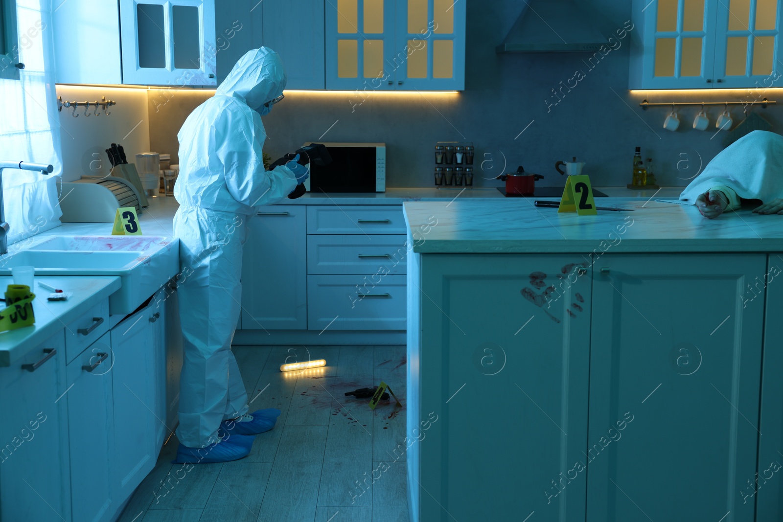 Photo of Forensic expert with camera working at crime scene and dead woman's body in dark room