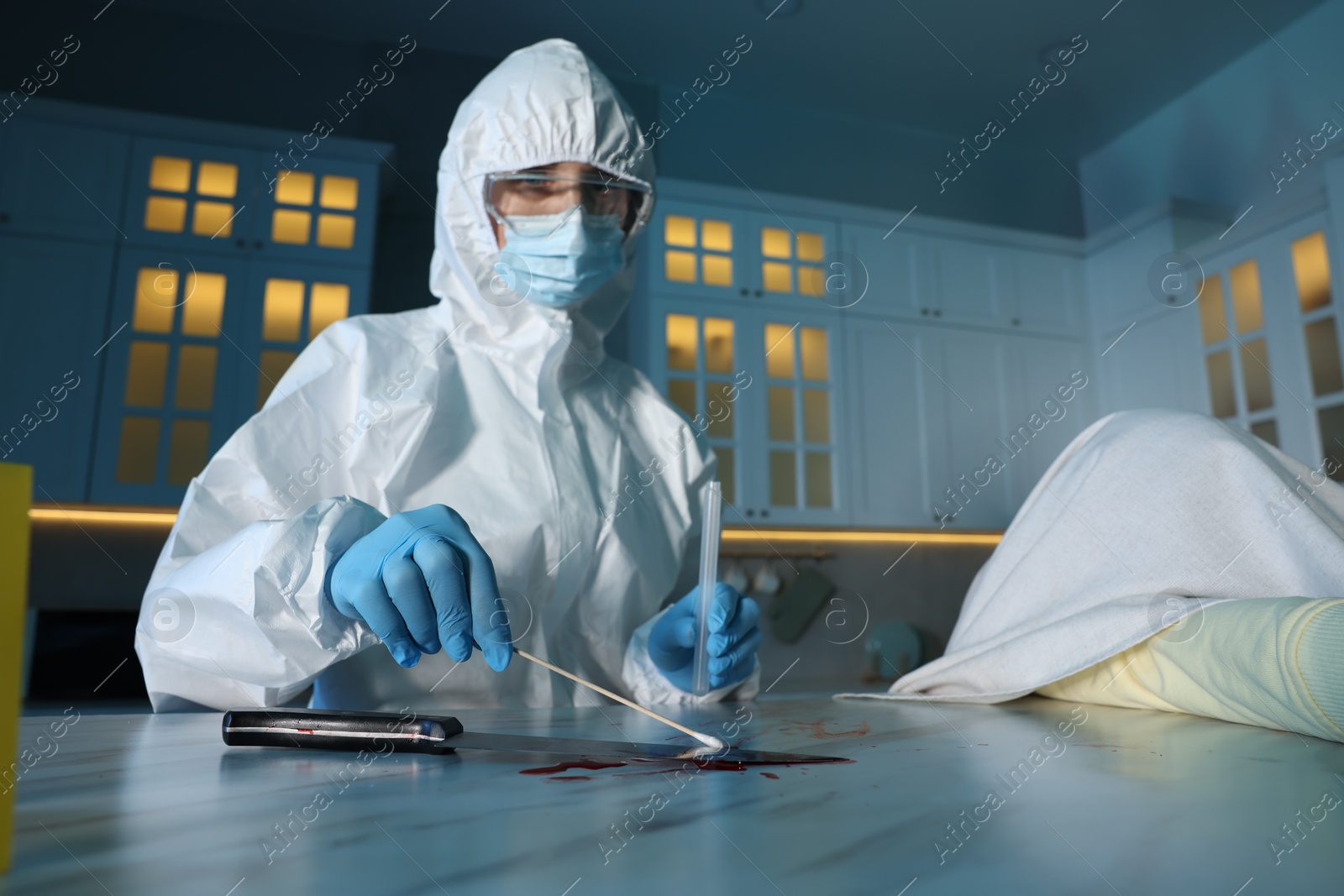 Photo of Forensic expert taking blood sample at countertop indoors, low angle view