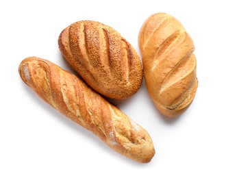 Photo of Different freshly baked bread loafs isolated on white, top view