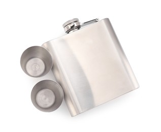 Photo of Metal hip flask and cups isolated on white, top view