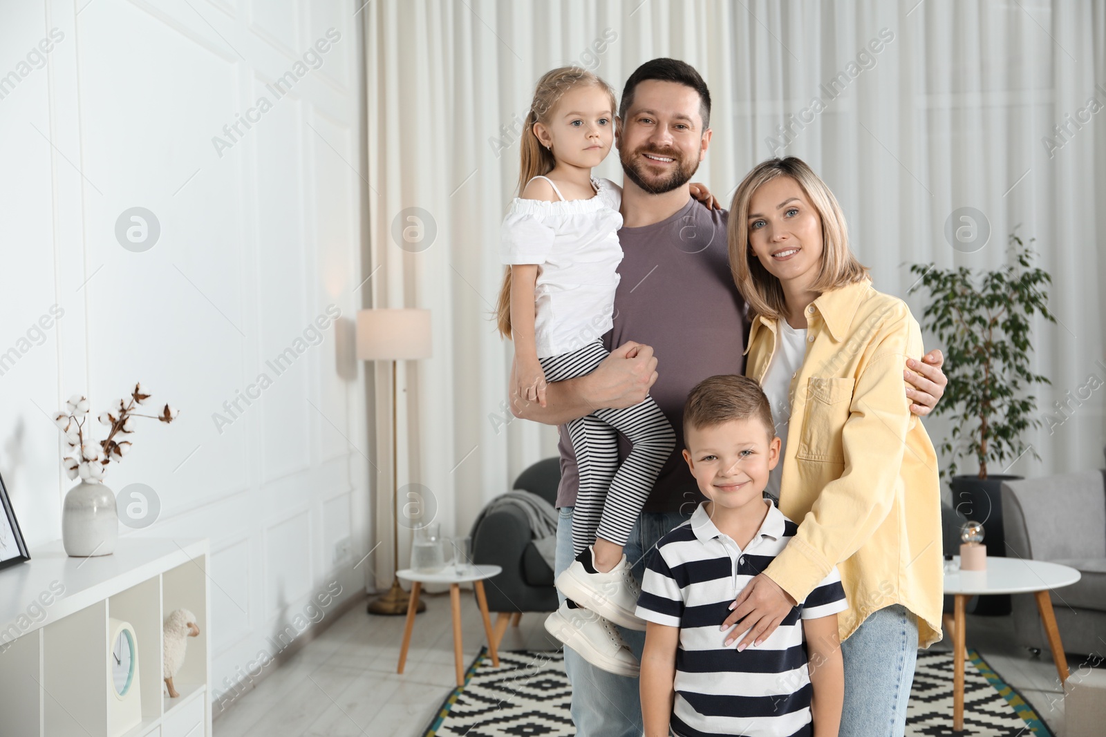 Photo of Happy parents and their children at home