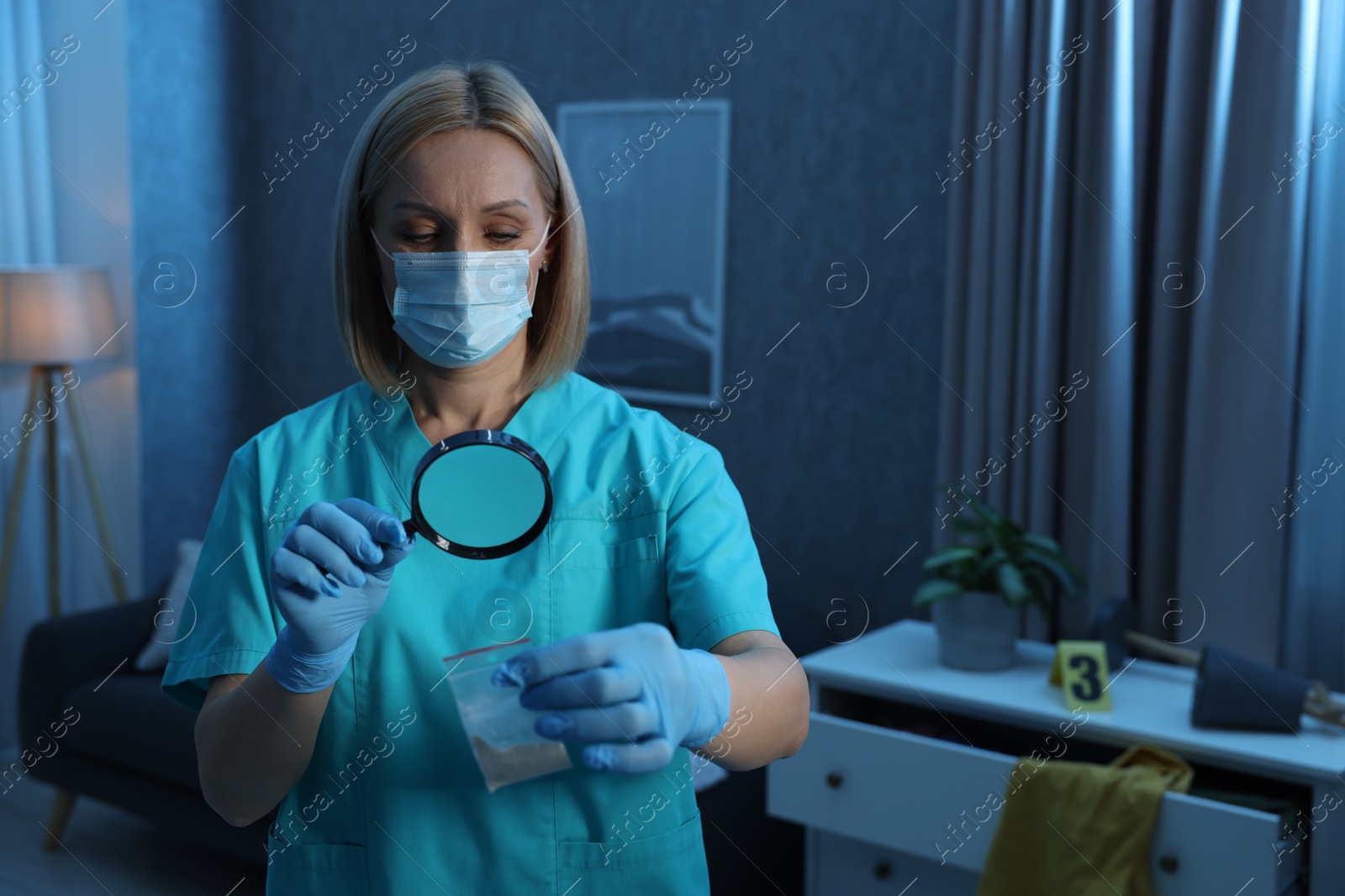 Photo of Forensic expert examining plastic bag with drug powder through magnifying glass at crime scene indoors. Space for text