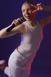 Photo of Beautiful talented singer performing on purple background