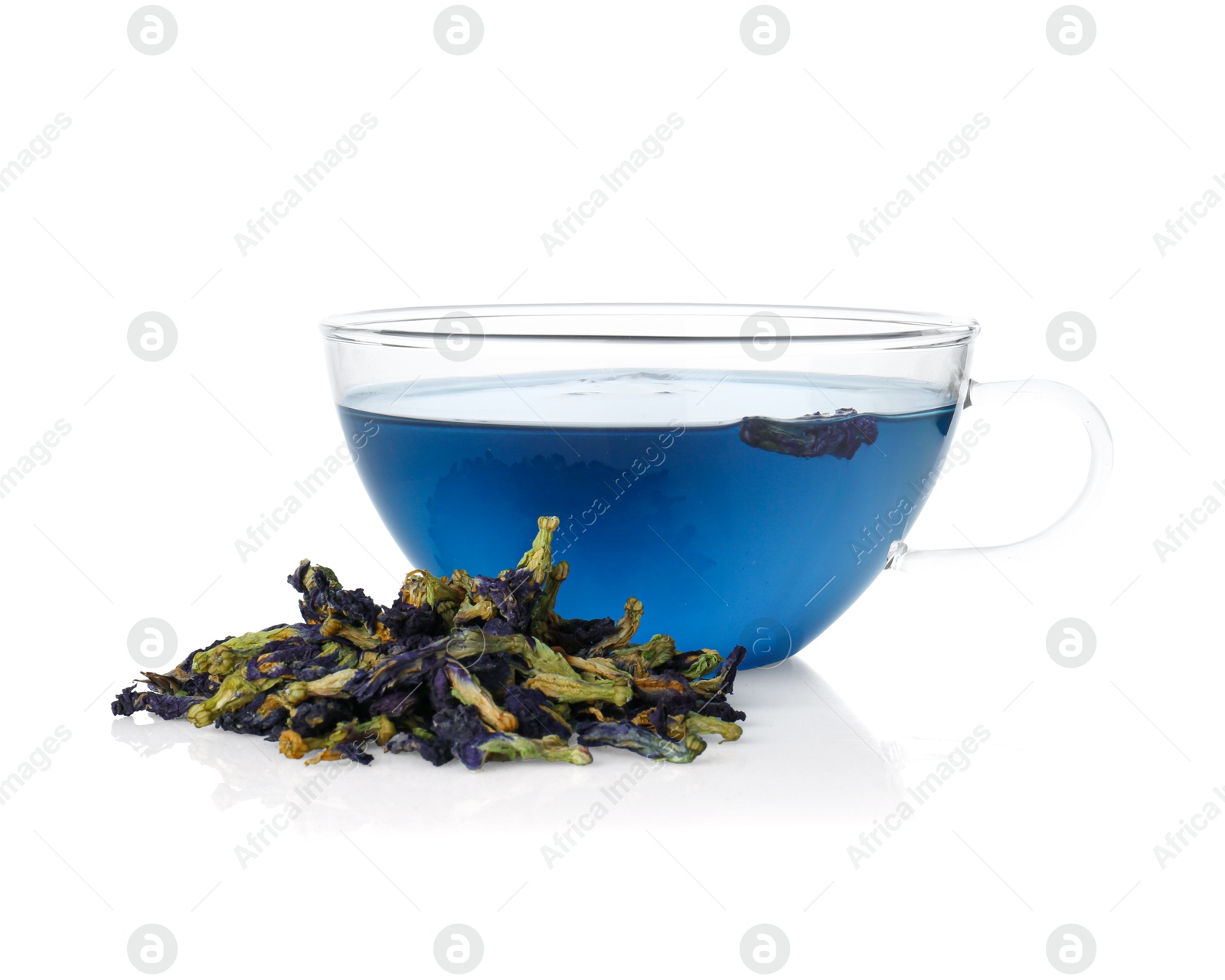 Photo of Delicious butterfly pea flower tea in glass cup and dry petals isolated on white