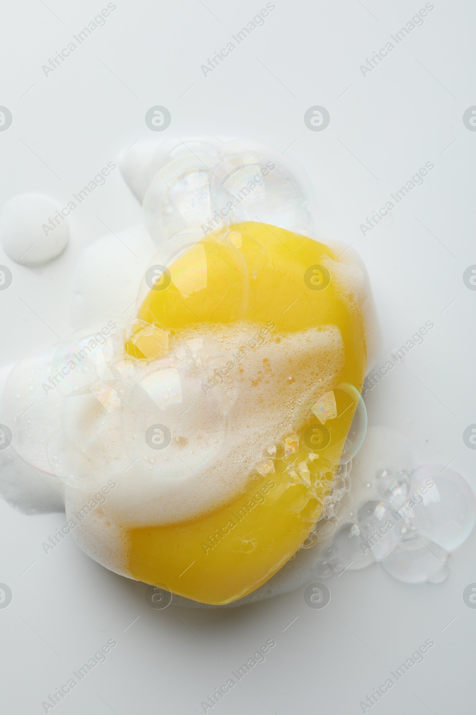 Photo of Soap bar with foam on white background, top view