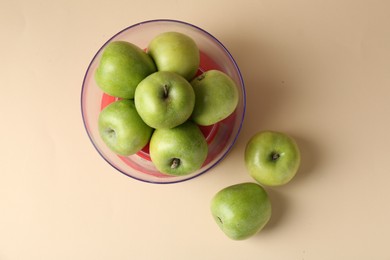 Photo of Kitchen scale with apples on beige background, top view