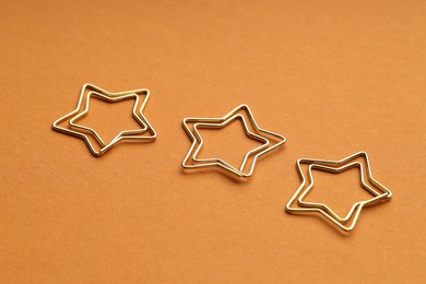 Photo of Star shaped paper clips on orange background