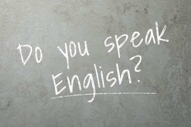 Image of Do You Speak English? text on grey textured background. Language course