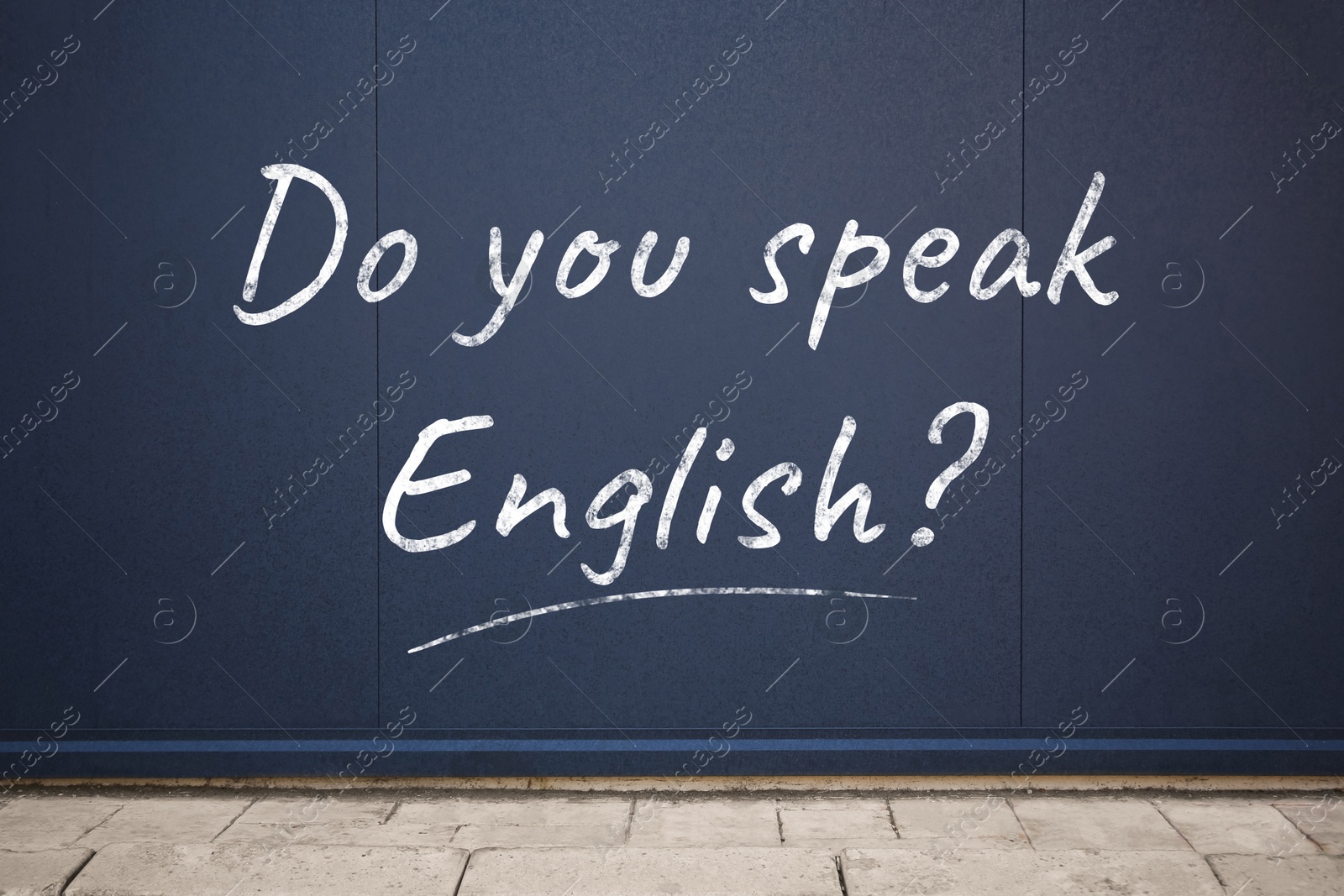 Image of Do You Speak English? text on dark blue wall outdoors. Language course