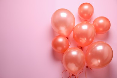 Photo of Colorful balloons on pink background, flat lay. Space for text