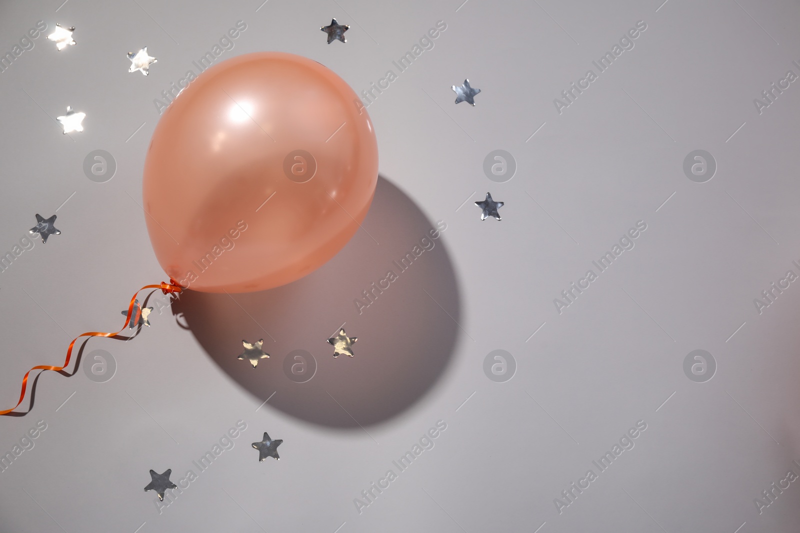 Photo of Festive balloon on grey background, top view. Space for text