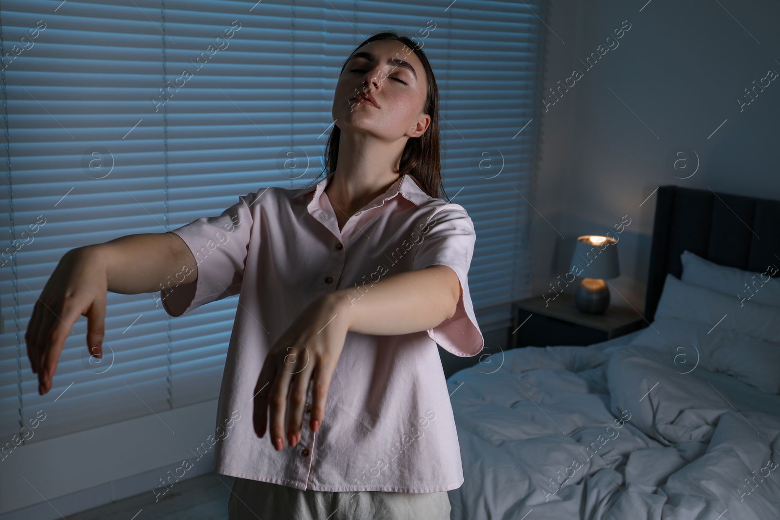 Photo of Young woman suffering from sleepwalking at home