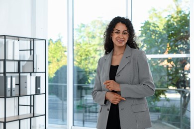 Photo of Portrait of young woman wearing stylish suit indoors. Space for text